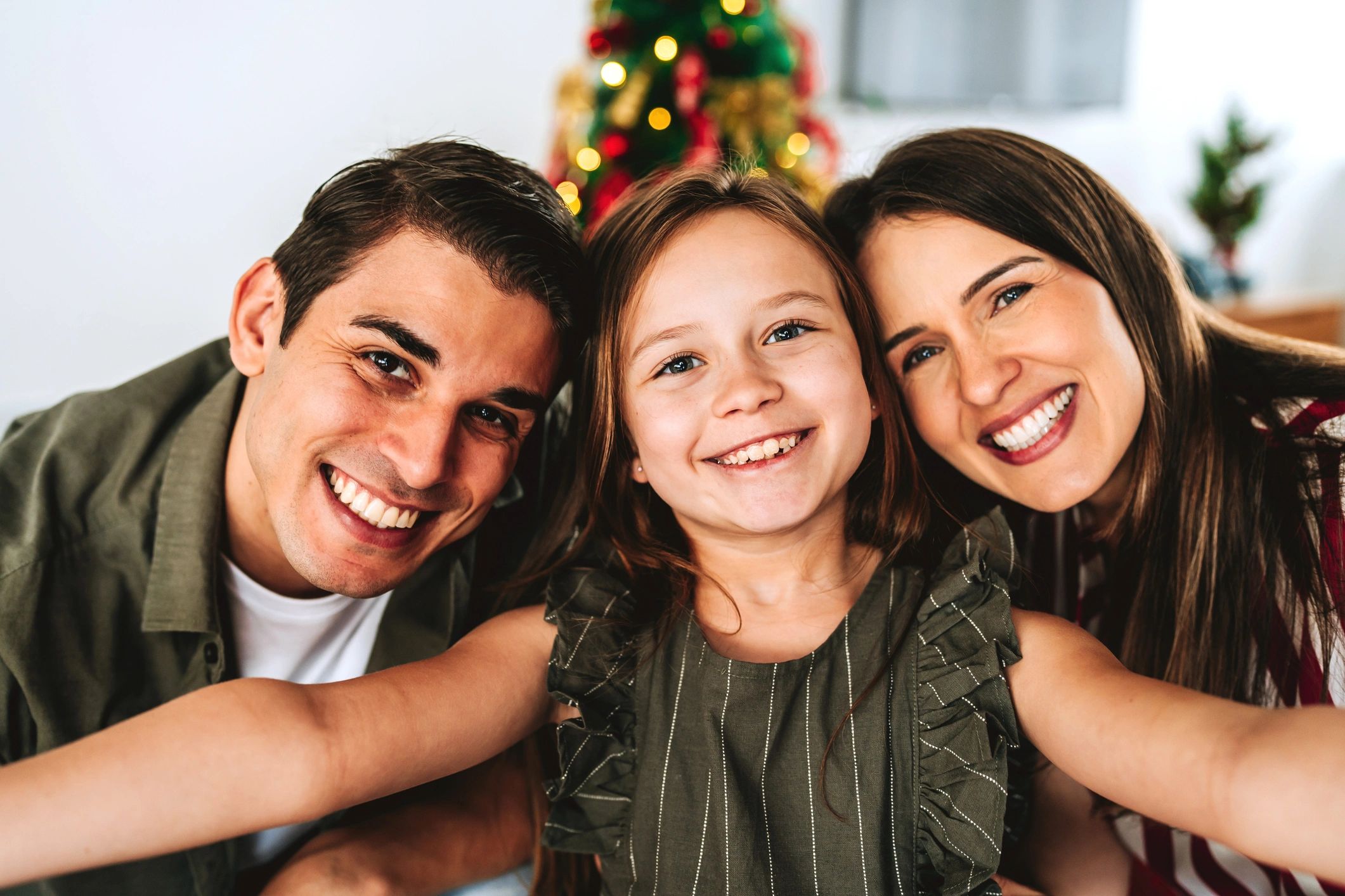 Family portrait by Christmas tree